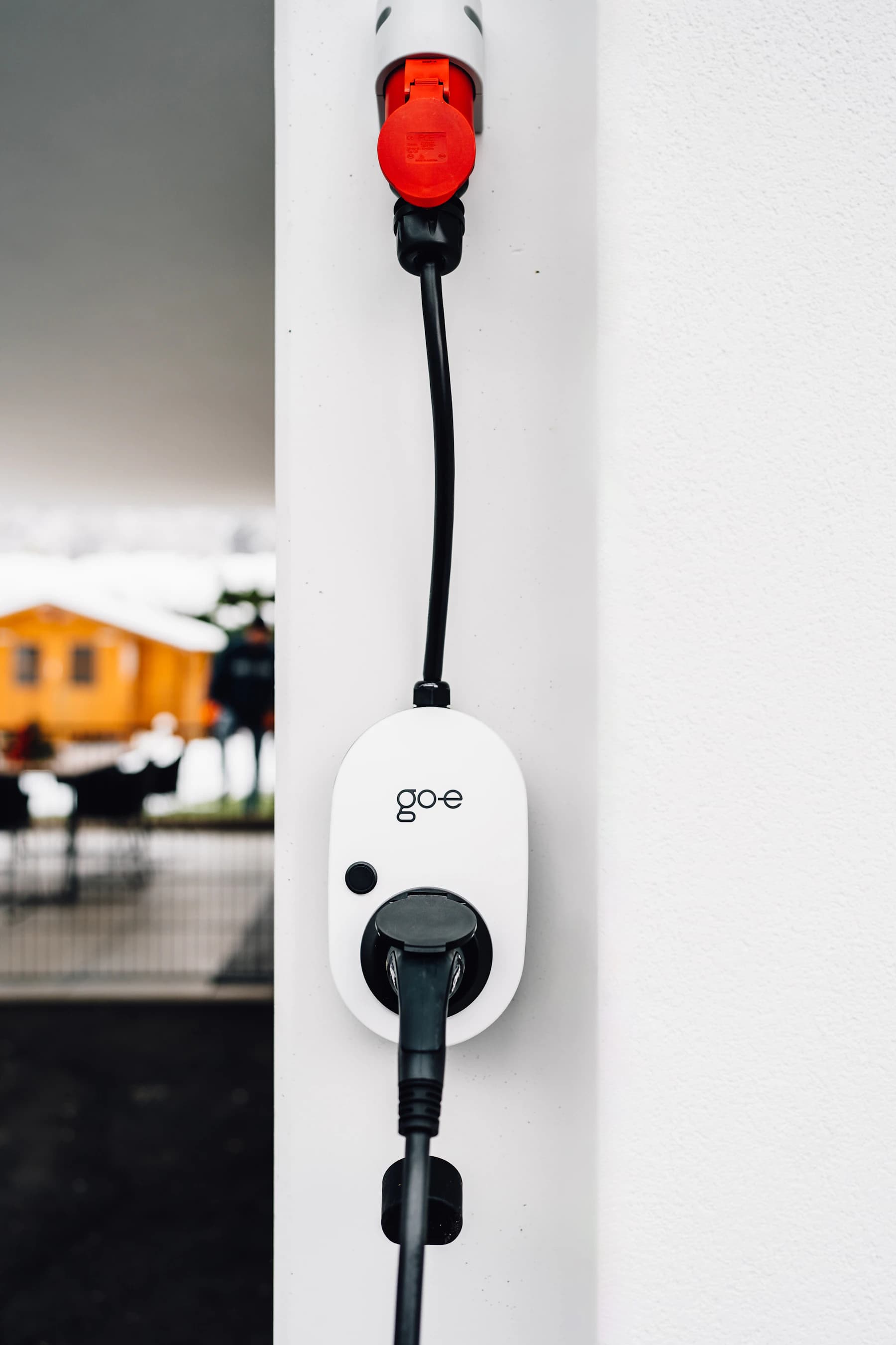 Electric vehicle charger mounted on a clean exterior wall